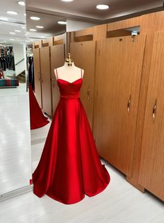 This exquisite red satin gown is elegantly showcased in a store, capturing attention with its vibrant hue and luxurious fabric. The dress exudes sophistication and allure, perfect for special occasions or formal events. Its flattering silhouette and attention to detail make it a standout choice for those seeking a glamorous and timeless look. With its captivating design and impeccable craftsmanship, this red dress is sure to make a lasting impression. Red Silk Dresses, Red Silk Prom Dress, Red Silk Gown, Flared Bridesmaid Dresses, Bridesmaid Dress Boho, Bridesmaid Satin Dresses, Red Satin Prom Dress, Red Satin Gown, Bridesmaid Dresses Red