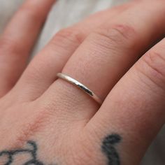 This adjustable hammered sterling silver ring is designed for both men and women who enjoy wearing minimalist style jewelry. This ring is super lightweight and comfortable, making it the perfect everyday wear with any outfit. Stack it or mix and match with other metals. Puffy fingers are no match for this ring! Completely handcrafted by me (Kahlia) in Washington State out of my school bus work studio. Handmade with raw 925 sterling silver wire, this ring is hammered to perfection and polished to