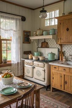 an old fashioned stove in a kitchen with wooden cabinets and white dishes on the table