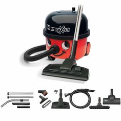 a red and black vacuum is shown with its cleaning tools on it's side