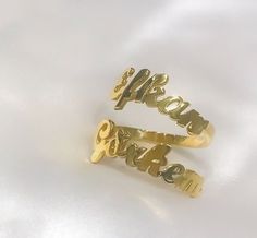 This 14K solid gold double name ring  is a  meaningful gift for your loved one or a special treat just for yourself . You can buy this personalized two name ring as an engagement ring which includes couple's names . This affordable and thoughtful custom multiple name ring gift will surely be treasured by your loved one.   *FEATURES Material : 14 K Solid Gold  Colour : gold * PACKAGING Jewels will be sent nicely wrapped and packed in a box! If specific goods are intended as gifts, please leave us a note. We'll use a special box separately and include a gift card for you! The most unique jewelry you can find, a perfect gift for you and your loved one ... Birthday Gift , Wedding Gift , Gift For Love ,  Bridesmaid Gift , Anniversary Gift , Mother's Day Gift , Graduation Gift * SHIPPING DETAILS Personalized Gold Couple Rings For Wedding, Customized Gold Engraved Promise Ring, Customized Gold Engraved Wedding Ring, Gold Wedding Rings With Name Detail, Gold Wedding Rings With Name, Gold Engraved Names Ring For Wedding, Gold Engraved Ring With Names For Wedding, Customized Gold Open Ring, Customized Gold Engraved Elegant Ring