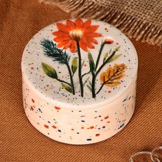 a white box with orange flowers painted on it