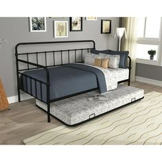 a daybed with a trundle bed frame and mattress on it in a room