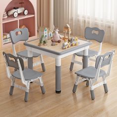 a child's table and chairs in a room