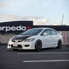 a white car parked in front of a store