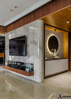 a living room with a large television on top of a wooden entertainment center next to a wall mounted flat screen tv