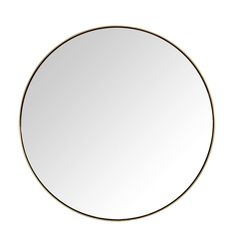 a round mirror on a white wall with a black frame and gold trim around the edges