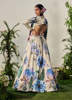 Celebrate summer with this pastel floral lehenga, featuring crystal highlights and beadwork at the waistband. The skirt's blooming print adds vibrant character, while the blouse with a sweetheart neckline and full sleeves completes the look. Includes a matching dupatta. White Anarkali Lehenga With Floral Print, White Floral Print Sharara For Wedding, Multicolor Floral Print Lehenga For Reception, Floor-length Floral Lehenga For Reception, Wedding Lehenga With Printed Motifs In Maxi Length, Party Anarkali Lehenga With Floral Print, Wedding Lehenga With Printed Motifs, Fitted Floral Print Sharara For Reception, Floral Print Floor-length Sharara For Wedding