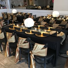 the tables are set with black and gold linens