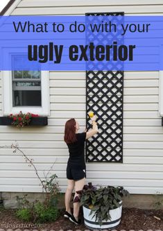 a woman standing in front of a house holding an object up to her face with the words, what to do with your ugly exterior