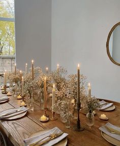 a long table with candles and plates on it