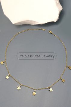 Introducing our Star Necklace, a dazzling piece of jewelry that combines elegance and durability. Made from high-quality stainless steel with a luxurious 18K gold finish, this necklace features delicate star-shaped pendants that are sure to catch the eye. Perfect for any occasion, it's a star-studded addition to any outfit. • Product Details: length: 17.5" Charm size: .4" ext: 3" ext clasp: Lobster Claw Metal finish: Stainless Steel 18K Gold product: Lead & Nickel Compliant anti-tarnish: Tarnish Free, Non-Tarnish Star-shaped Stainless Steel Jewelry With Adjustable Chain, Stainless Steel Star Jewelry With Adjustable Chain, Gold Star-shaped Jewelry, Star-shaped Chain Necklace As Gift, Star-shaped Chain Necklace For Gift, Star-shaped Metal Necklace As Gift, Gold Stainless Steel Jewelry With Star Charm, Star-shaped Metal Necklaces As Gift, Star-shaped Metal Necklaces For Gifts