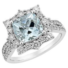 a ring with an aqua blue diamond surrounded by white diamonds