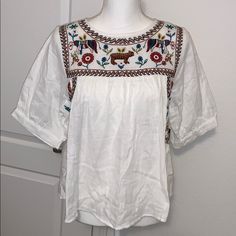 Nwt Size Small 22” Pit To Pit 23” Length Beautiful Embroidery. Very Light White Folk Embroidered Top With Embroidered Hem, White Bohemian Top With Geometric Embroidery, White Bohemian Top With Intricate Embroidery, White Embroidered Neckline Top For Spring, White Folk Embroidered Top With Floral Print, Winter Wear Women, Ruffle Top Blouses, Black Floral Top, Small Sweater