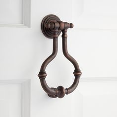 a close up of a door handle on the side of a white door with wood handles