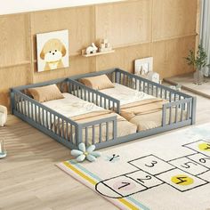 a baby's room with two cribs and a rug on the floor