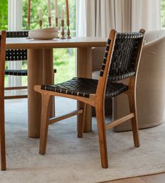 a wooden table with two chairs and a bowl on it