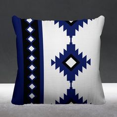 a blue and white pillow sitting on top of a table