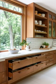 a kitchen with wooden cabinets and white counter tops