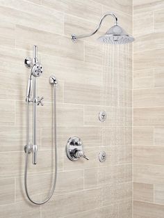 a shower head and hand shower in a bathroom with white tile wall tiles on the walls