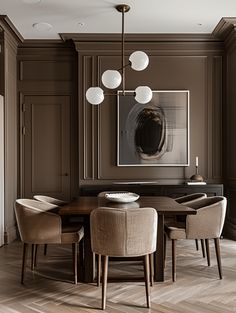 an elegant dining room with brown walls and wood flooring