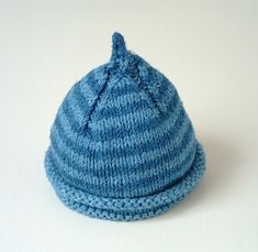 a blue knitted hat sitting on top of a white table