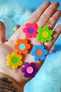 "I love these rainbow crazy daisy earrings in these fun bold colors! Made of lightweight acrylic, these mismatched daisies have different colored centers and are finished with hypoallergenic gold-plated brass fish hooks for closure. Materials: acrylic, hypoallergenic gold-plated brass hardware Measurements: 5.1\" drop length, 1.1\" width, .5oz weight" 70’s Earrings, Crazy Earrings, 90s Earrings, Funny Accessories, Crazy Daisy, Neon Flowers, Retro Earrings, Retro Accessories, Fish Hooks