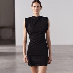 Dress Made Of Knit Fabric. Sleeveless With High Collar, Shoulder Pads, And Pleat Detail. Back Hidden In-Seam Zip Closure. Flattering Sleeveless Black Bodycon Dress, Chic Sleeveless Stretch Dress By Zara, Flattering Sleeveless Black Mini Dress, Sleeveless Stretch Mini Dress For Work, Sleeveless Black Bodycon Dress, Elegant Stretch Sleeveless Dress By Zara, Elegant Sleeveless Stretch Dress By Zara, Sleeveless Black Mini Dress, Zara Elegant Sleeveless Stretch Dress