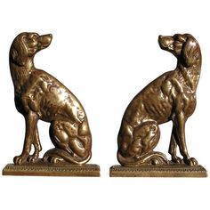 two golden dog figurines sitting side by side