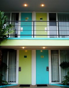 a multicolored apartment building with two balconies and one door on the second floor