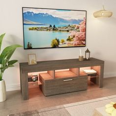 a flat screen tv mounted to the side of a wall above a wooden entertainment center