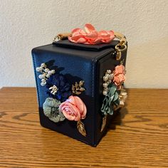 This Is A Gorgeous Little Purse For Summertime, Weddings, Dinners Out Or Proms. Take It Anywhere. New, Never Used, 6” Tall, 4.75”Wide, Has Flowers On Two Sides, And One Flower On Top, Very Clean On The Interior, Has 5 Brass Tacks On The Bottom, The Handle Is Blue With Gold On The Underside. Comes With A Chain That Is Twisted With Gold And Blue So You Can Use It As A Crossbody Bag. New But Does Not Have Tags. Pink Pouch Box Bag For Gift, Chic Box Bag With Removable Pouch For Gift, Pink Square Box Bag For Gifts, Chic Pink Box Bag For Gift, Blue Top Handle Box Bag As Gift, Blue Top Handle Box Bag For Gift, Elegant Box Bag With Removable Pouch For Gift, Elegant Blue Handheld Box Bag, Elegant Handheld Blue Box Bag