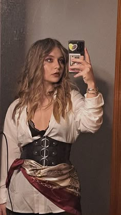 a woman wearing a pirate costume taking a selfie