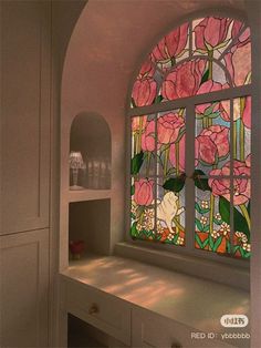 a stained glass window with pink flowers on it