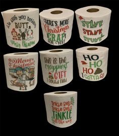 six rolls of toilet paper with christmas sayings on the front and back, all decorated in different colors