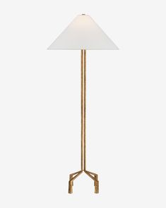 a floor lamp with a white shade on the top and a gold base, against a white background