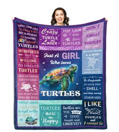 a woman is holding up a blanket with turtles on it and other words written in different languages