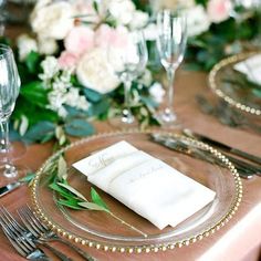 the table is set with silverware and place settings