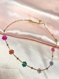 This beautiful gold choker necklace has colorful beaded flowers on it! Perfect detail to any outfit!  Sizing: Length is about 15-17 inches Material: stainless steel Gold Chain Choker, Fuzzy Socks, Gold Choker Necklace, Gold Choker, Chain Choker Necklace, Chain Choker, Wire Work, Beaded Flowers, Stainless Steel Chain