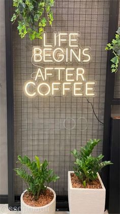 two white planters sitting on top of a counter next to a sign that says life begins after coffee