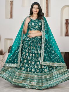 Our adorable teal green zari embroidered jacquard lehenga choli. This stunning ensemble features a teal green color jacquard lehenga with intricate zari embroidered work and sequin detailing. Paired with a matching jacquard choli adorned with similar zari embroidery and sequin work, along with a net dupatta featuring four side embroidered lace work, this outfit exudes elegance and charm.
The semi-stitched lehenga can be adjusted up to 42 inches, providing a comfortable and flattering fit for a w Green Brocade Sharara With Zari Work, Unstitched Green Lehenga With Zari Work, Green Choli With Intricate Embroidery And Traditional Drape, Green Lehenga With Zari Work For Eid, Green Art Silk Choli With Intricate Embroidery, Green Lehenga With Resham Embroidery For Eid, Green Lehenga With Intricate Embroidery For Festive Occasions, Green Lehenga With Zari Work For Navratri, Bollywood Green Lehenga With Zari Work