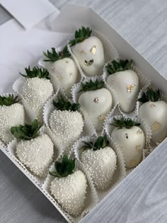 a box filled with white chocolate covered strawberries