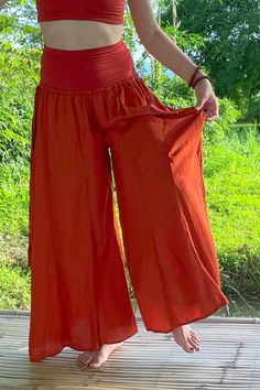 Long flowy Persephone Palazzo Pants come in one size, fits sizes 0-14. Soft stretchy viscose waist band can be worn high or folded over. Pull string around hips created snug fit for smaller body sizes. Available in Onyx, Sage and Rust. Ethically handmade of tree pulp eco Lyocell fabric its silky, luxurious and stunning, also known as vegan silk. Matching Bell Sleeve Lily Tops, Halter Tops, and Tube Tops make gorgeous eco outfits. Mix and match styles and colors. Solid Color Wide Leg Pants With Waistband, High Waist Bohemian Pants, Stretch Harem Pants For Summer, High Waist Solid Color Yoga Pants For Summer, Wide Leg Pants With Waistband, Versatile Rayon Bottoms With Elastic Waistband, Versatile Bottoms With Elastic Waistband In Rayon, Versatile Bottoms With Elastic Waistband, High Waist Harem Pants With Elastic Waistband