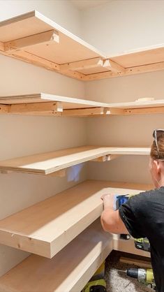 a woman in black shirt working on shelves