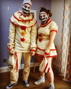 two people dressed in costumes standing next to each other