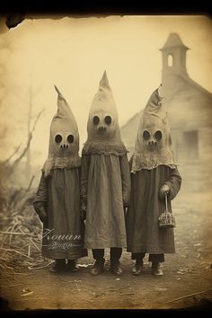 three children dressed up in costumes standing next to each other with creepy faces on their heads