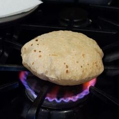 an uncooked tortilla sitting on top of a burner in the oven