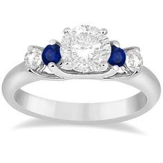 a diamond and blue sapphire engagement ring with two stones on the side, set in white gold