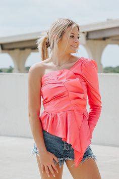 One shoulder hot pink top.Syd is wearing a size smallRuffled hemSmocked backSize Chart:Small: Bust: 34 in.Medium: Bust: 36 in.Large: Bust: 38 in.This item is final sale. Ruffle Hem Tops For Spring Night Out, Spring Ruffle Hem Top For Night Out, Ruffle Hem Top For Night Out In Spring, Trendy One-shoulder Top With Ruffles, Spring Night Out Blouse With Ruffle Hem, Spring Ruffle Hem Blouse For Night Out, Pink Off-shoulder Top For Brunch, Pink Ruffle Hem Top For Day Out, Pink Tops With Ruffle Hem For Day Out