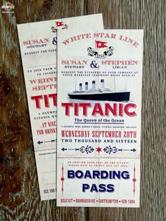 two white star line boarding pass tickets sitting on top of a wooden table